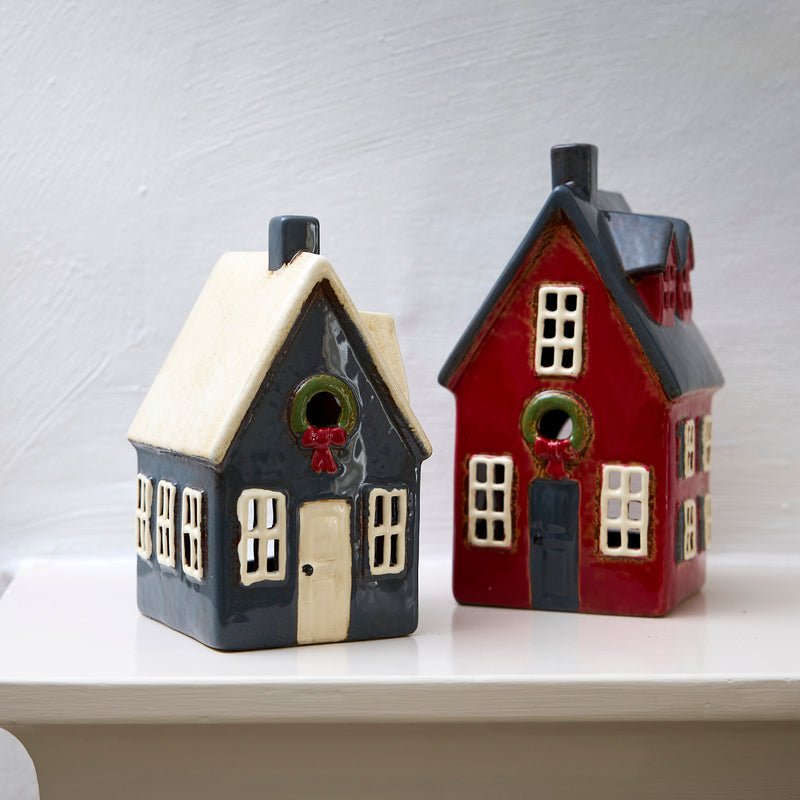 Hand-painted red Christmas tealight cottage glowing with candle inside