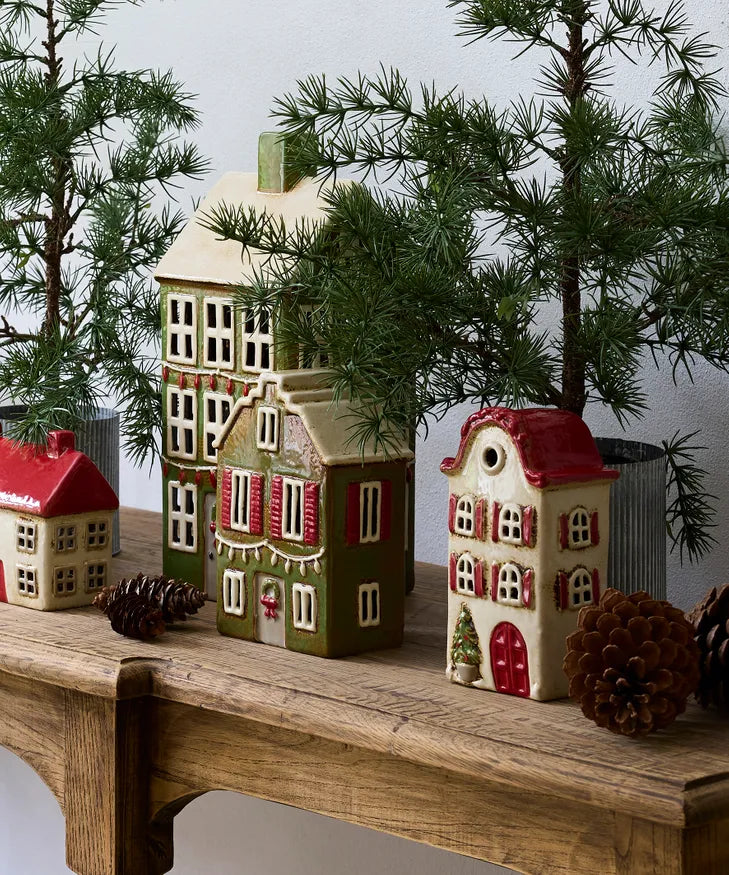 Christmas village display with green ceramic tea light house