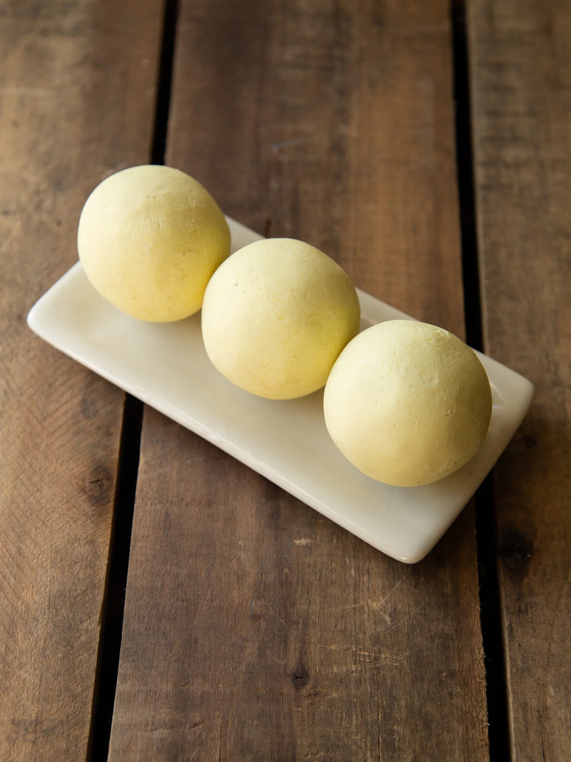 Handmade 120g olive oil soap ball scented with ylang ylang, patchouli and orange essential oils.