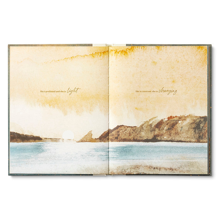 Open book with a scenic illustration of a mountain and water on a white background