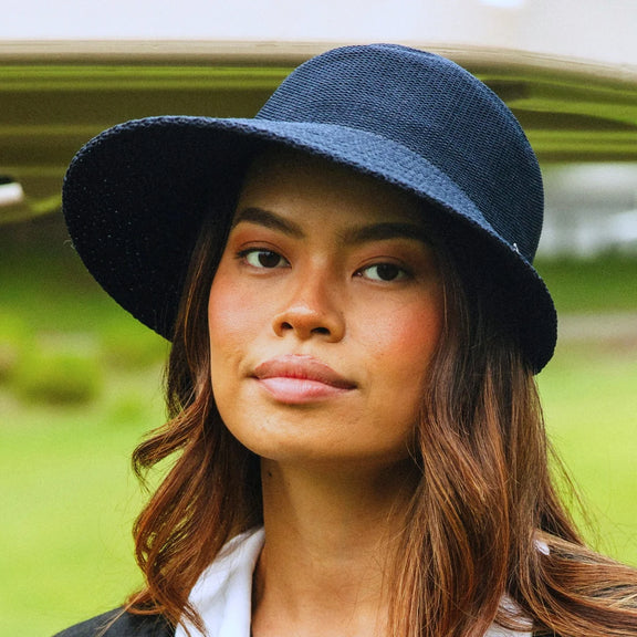 Navy ponytail-friendly cap for golf and travel