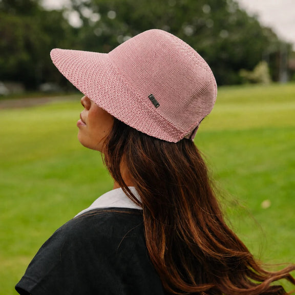 Pink women’s travel cap with elongated front brim