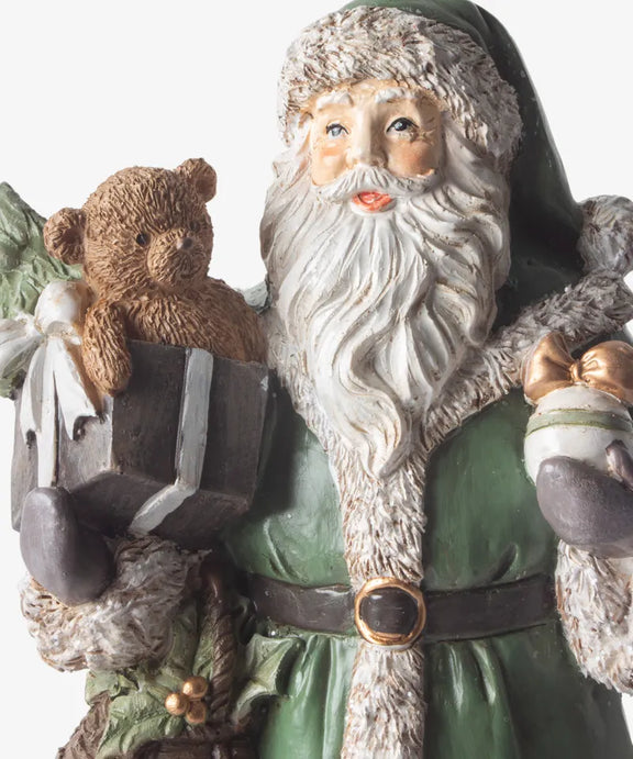 Festive Santa in detailed green coat holding gifts and teddy bear 
