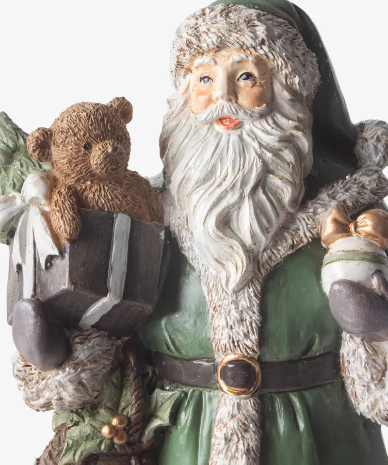 Festive Santa in detailed green coat holding gifts and teddy bear 