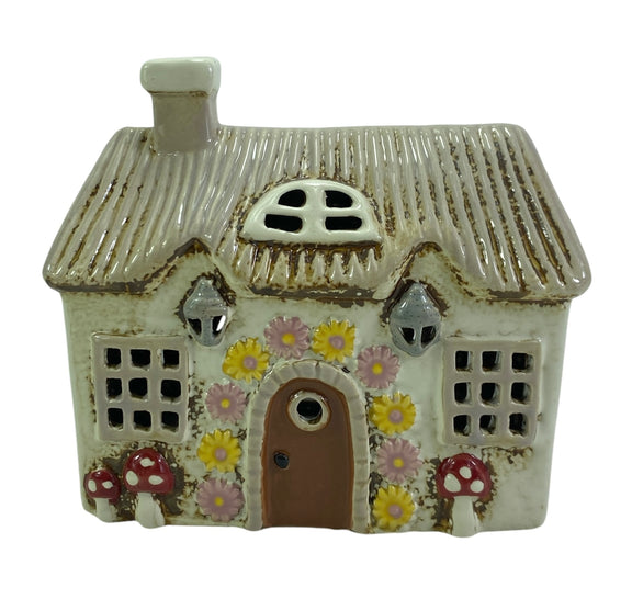 Fairy garden house with mushroom and floral details