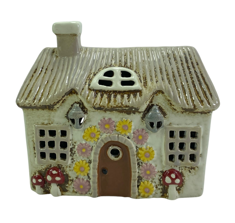 Fairy garden house with mushroom and floral details