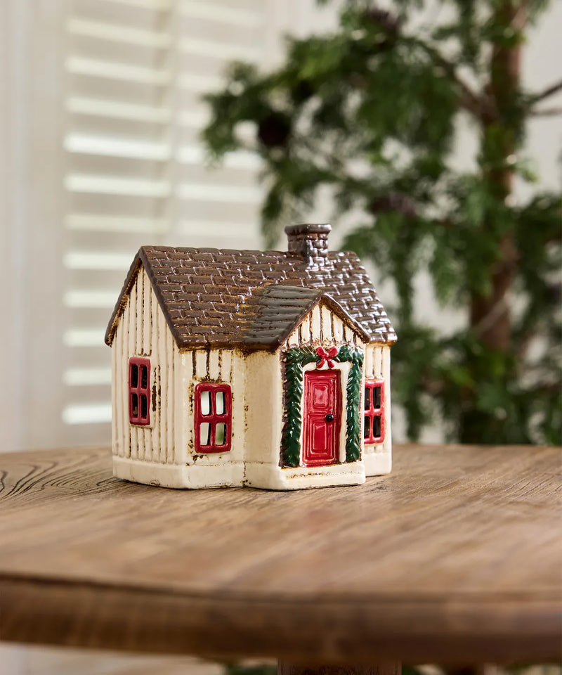 Off white Scandinavian ceramic Christmas cottage with festive garland 